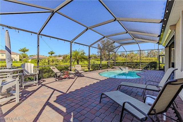 view of swimming pool featuring a lanai and a patio area