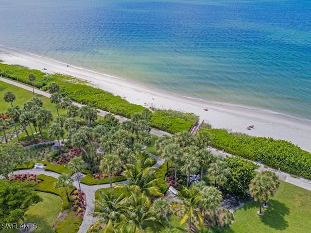 drone / aerial view featuring a water view and a beach view