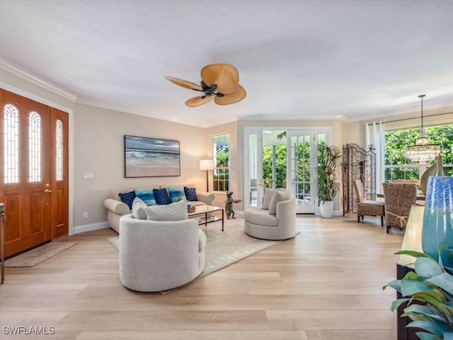 living room featuring ceiling fan, light wood-type flooring, and ornamental molding