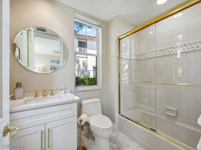 full bathroom featuring vanity, toilet, and bath / shower combo with glass door