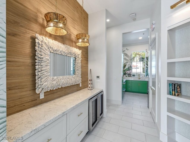 bar featuring white cabinetry, built in features, light tile patterned floors, and light stone counters