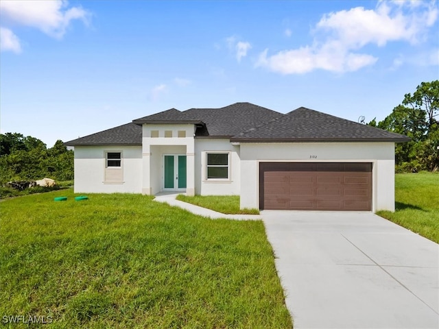 prairie-style home featuring a garage and a front yard