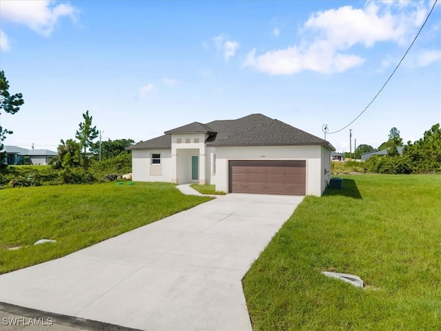 view of front facade with a garage and a front lawn