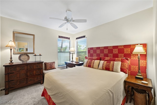 bedroom with ceiling fan and light carpet