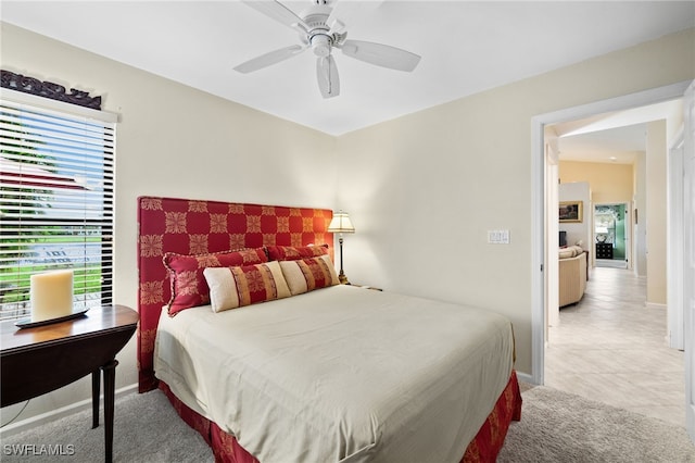 bedroom featuring light carpet and ceiling fan