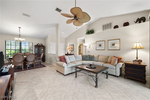 living room with ceiling fan with notable chandelier and vaulted ceiling