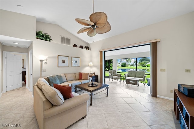 tiled living room with lofted ceiling and ceiling fan