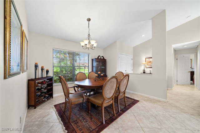 tiled dining area with an inviting chandelier and lofted ceiling