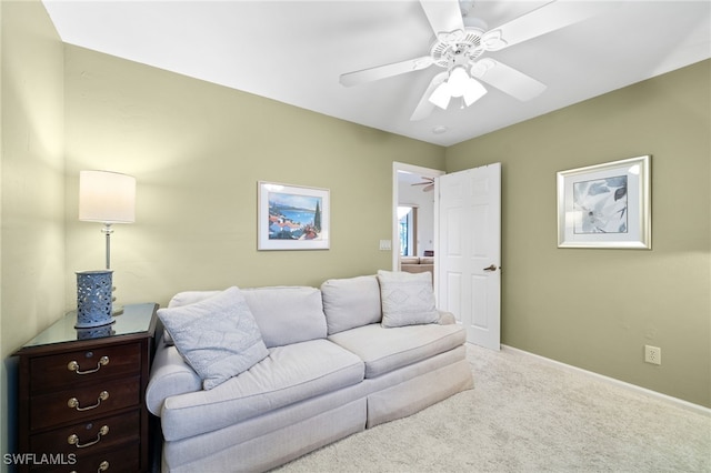 carpeted living room with ceiling fan