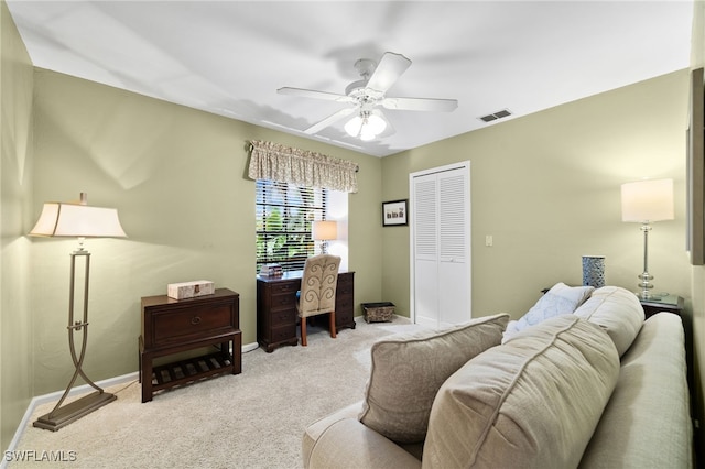 carpeted office space featuring ceiling fan