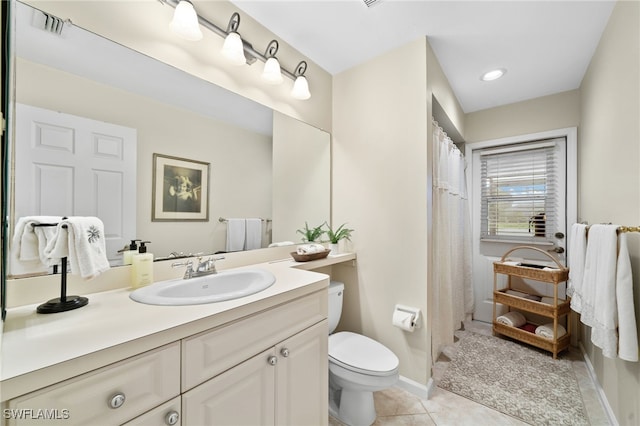 bathroom with tile patterned floors, toilet, and vanity