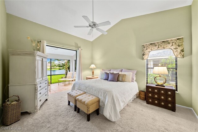 carpeted bedroom with vaulted ceiling, ceiling fan, and a water view