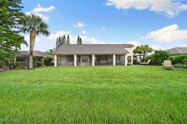 back of property with a sunroom and a lawn