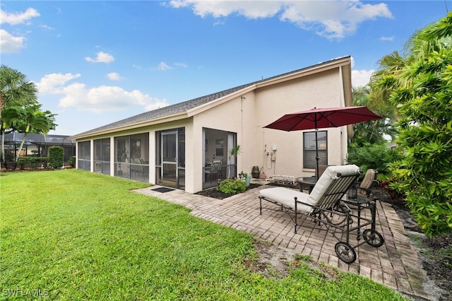 back of house featuring a patio, a sunroom, and a lawn