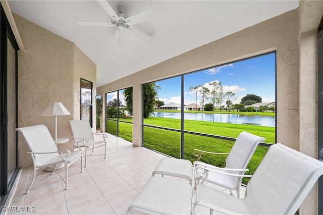 sunroom featuring a water view, ceiling fan, and vaulted ceiling