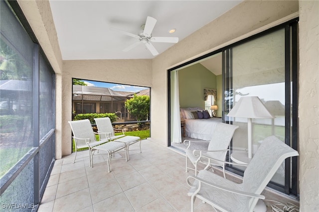 sunroom featuring vaulted ceiling and ceiling fan