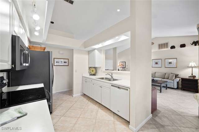 kitchen featuring lofted ceiling, sink, range with electric stovetop, dishwasher, and white cabinets