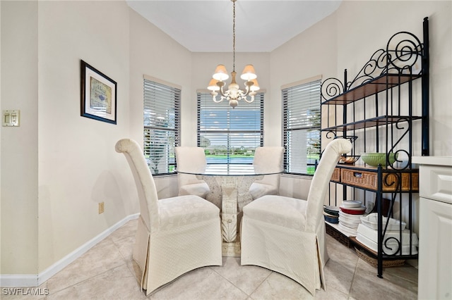 dining area with a notable chandelier and light tile patterned floors