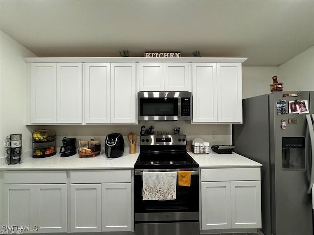 kitchen with white cabinets and appliances with stainless steel finishes