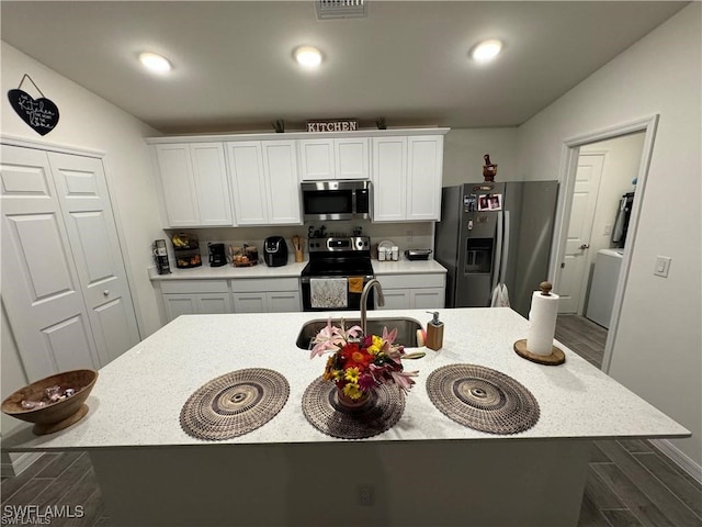 kitchen with a center island with sink, white cabinetry, sink, and stainless steel appliances