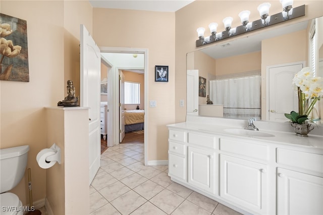 bathroom featuring vanity, toilet, and tile patterned floors