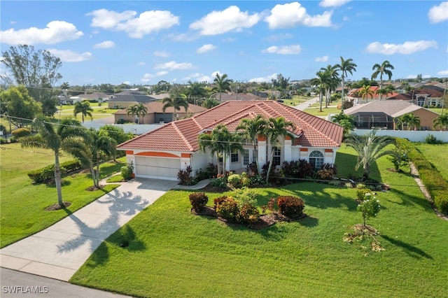 mediterranean / spanish-style home with a garage and a front lawn