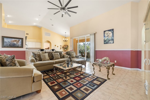 tiled living room with ceiling fan with notable chandelier and lofted ceiling