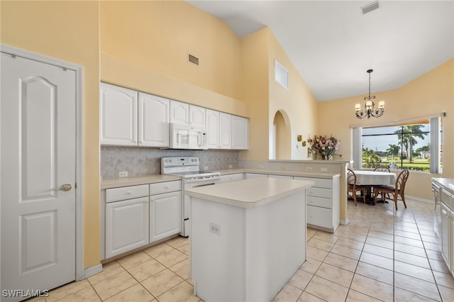 kitchen featuring white cabinets, decorative light fixtures, white appliances, and a kitchen island