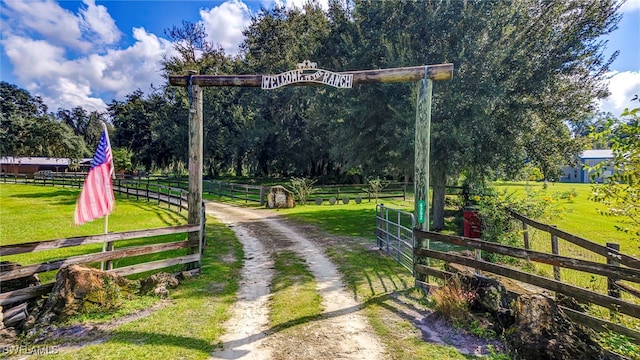 surrounding community with a rural view and a yard