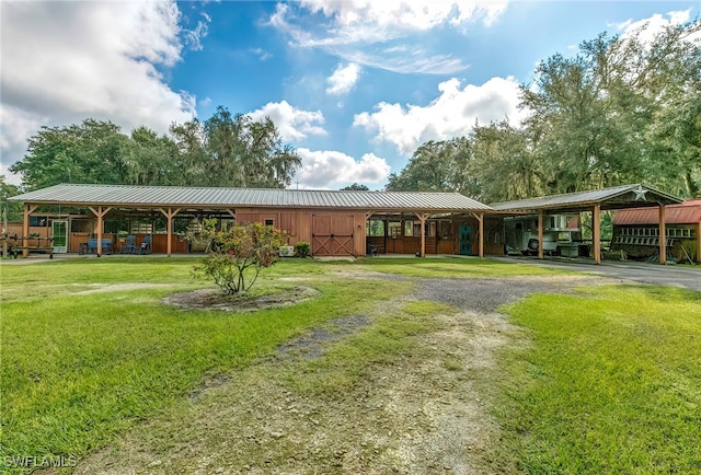 exterior space featuring a yard and a carport