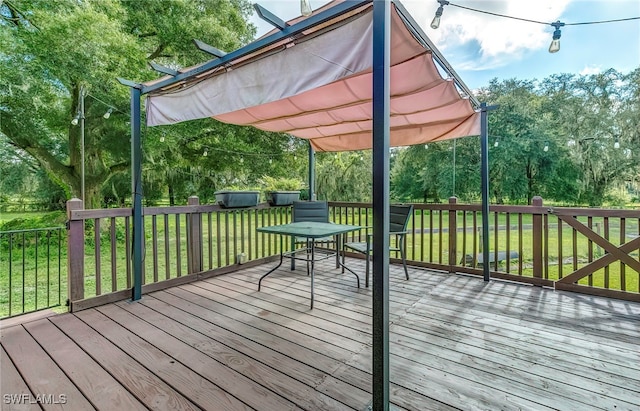 wooden terrace featuring a yard and a pergola