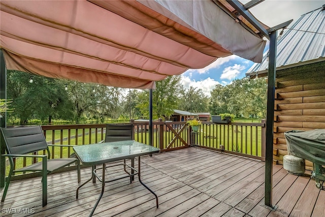 wooden deck featuring a yard