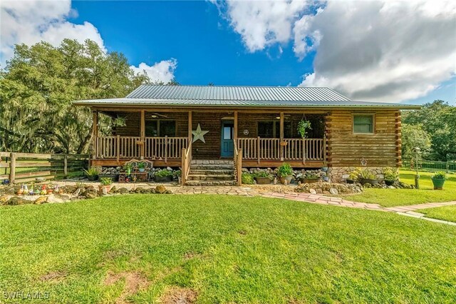 log home with a front yard and covered porch