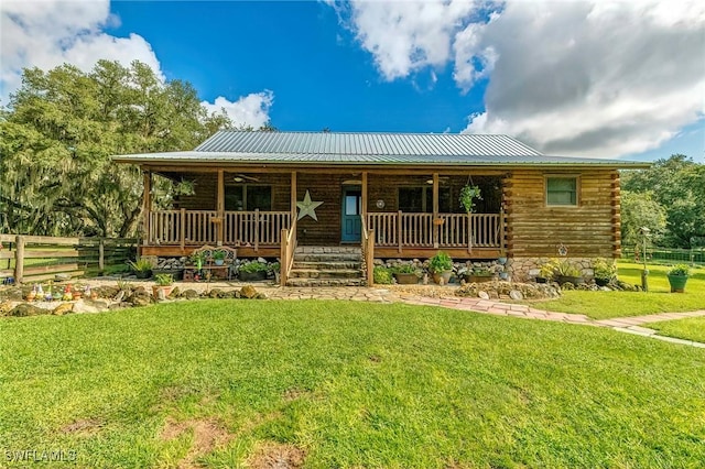 log-style house with a porch and a front yard