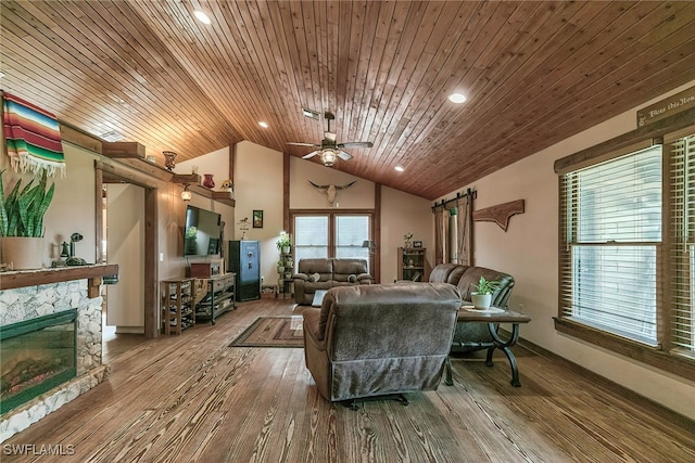 living room featuring lofted ceiling, a fireplace, hardwood / wood-style floors, and wooden ceiling