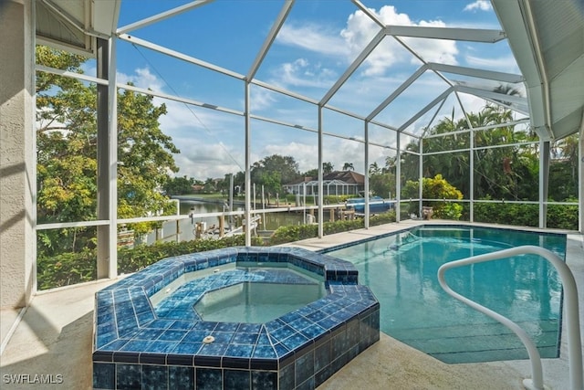 view of swimming pool with a lanai, an in ground hot tub, and a water view