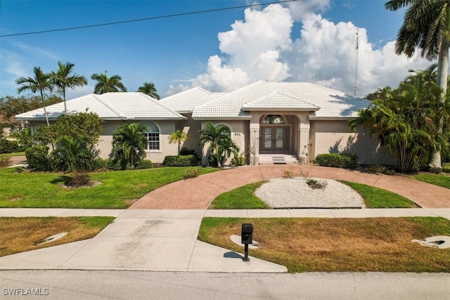 mediterranean / spanish-style home with a front lawn