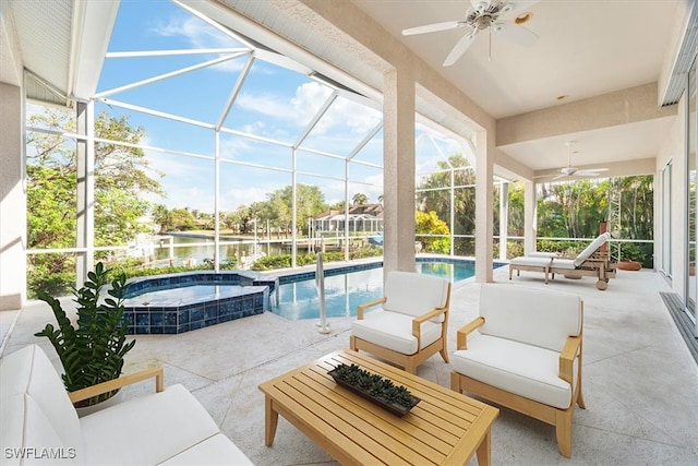 view of patio with a lanai, ceiling fan, a swimming pool with hot tub, and a water view