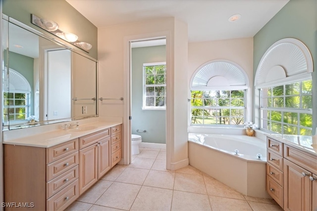 bathroom featuring a bathing tub, tile patterned flooring, vanity, and toilet