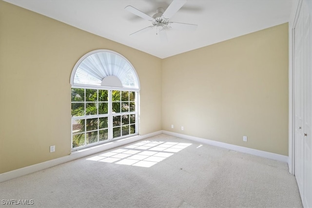 empty room with light colored carpet and ceiling fan