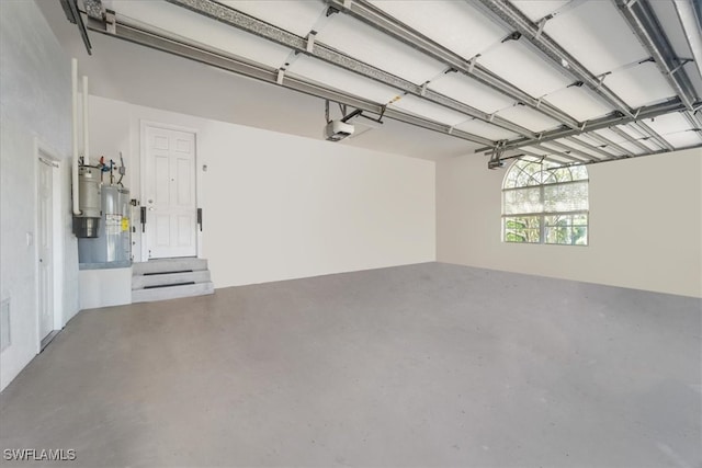 garage with water heater and a garage door opener