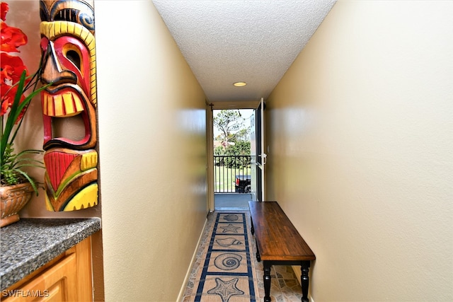 hall featuring a textured ceiling and tile patterned floors