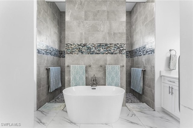 854 SW 15th Ave, Cape Coral, FL 33991 - bathroom featuring walk in shower, a freestanding tub, and marble finish floor