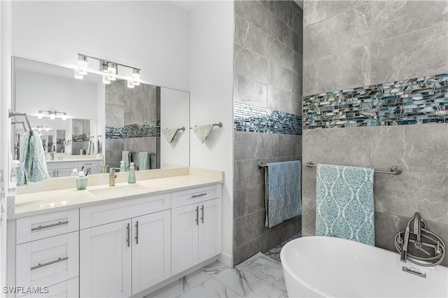 854 SW 15th Ave, Cape Coral, FL 33991 - full bath with vanity, marble finish floor, a freestanding tub, and tile walls