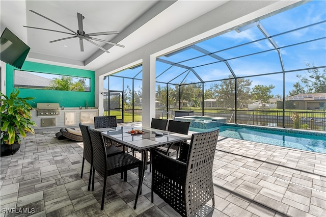 view of patio featuring ceiling fan, glass enclosure, an outdoor kitchen, a swimming pool with hot tub, and area for grilling