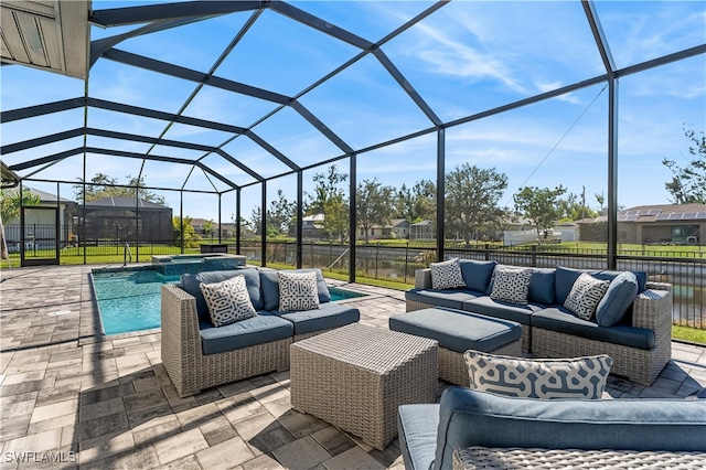 view of patio / terrace with an outdoor hangout area, glass enclosure, and a water view