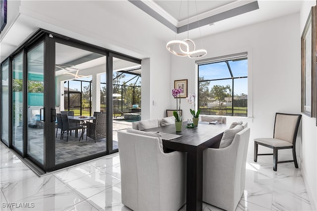 dining area with a raised ceiling and crown molding