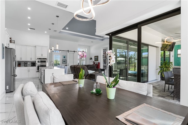 dining space featuring a barn door and sink