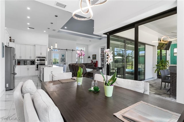 854 SW 15th Ave, Cape Coral, FL 33991 - dining space with visible vents, recessed lighting, a barn door, and a healthy amount of sunlight