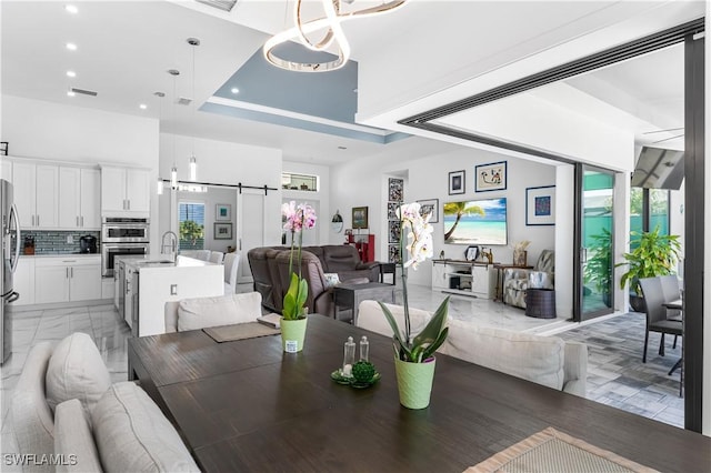 854 SW 15th Ave, Cape Coral, FL 33991 - dining area featuring an inviting chandelier, a towering ceiling, visible vents, and recessed lighting